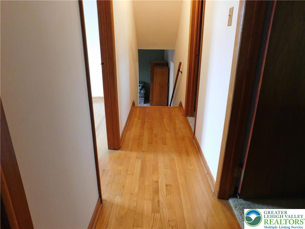 21 Will Barnesville, PA 18214 - Photo 17 of 23 Natural wood flooring extends through this inviting hallway, leading to further living spaces.