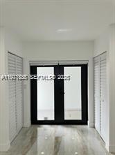 19823 Southwest 119th Court Miami, FL 33177 - Photo 12 of 33 a view of a refrigerator in kitchen and an empty room