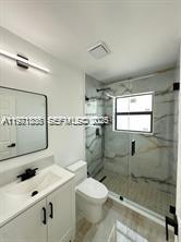 19823 Southwest 119th Court Miami, FL 33177 - Photo 19 of 33 a bathroom with a sink a toilet and shower