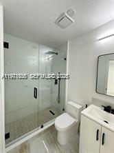 19823 Southwest 119th Court Miami, FL 33177 - Photo 20 of 33 a bathroom with a granite countertop sink a toilet and shower