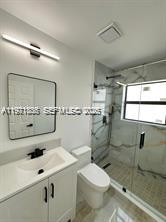 19823 Southwest 119th Court Miami, FL 33177 - Photo 21 of 33 a bathroom with a sink mirror and toilet