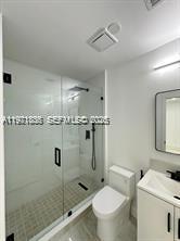 19823 Southwest 119th Court Miami, FL 33177 - Photo 22 of 33 a bathroom with a granite countertop sink a toilet and shower