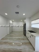 19823 Southwest 119th Court Miami, FL 33177 - Photo 6 of 33 a kitchen with granite countertop a stove and a refrigerator