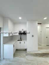 19823 Southwest 119th Court Miami, FL 33177 - Photo 8 of 33 a kitchen with stainless steel appliances kitchen island sink refrigerator and cabinets