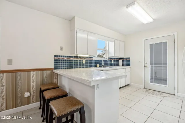 a kitchen with a sink a stove a refrigerator and cabinets