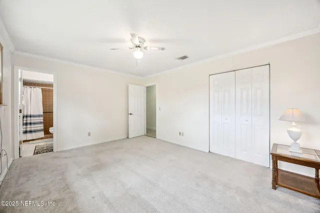 a view of an empty room with a fan