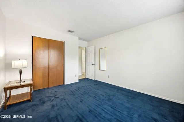 a view of an empty room and wooden floor