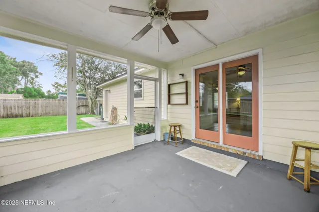a spacious bedroom with a large window and a balcony
