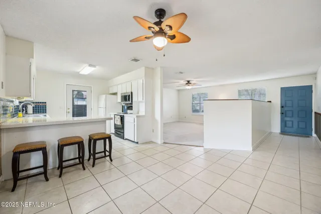 a kitchen with stainless steel appliances a refrigerator and a table