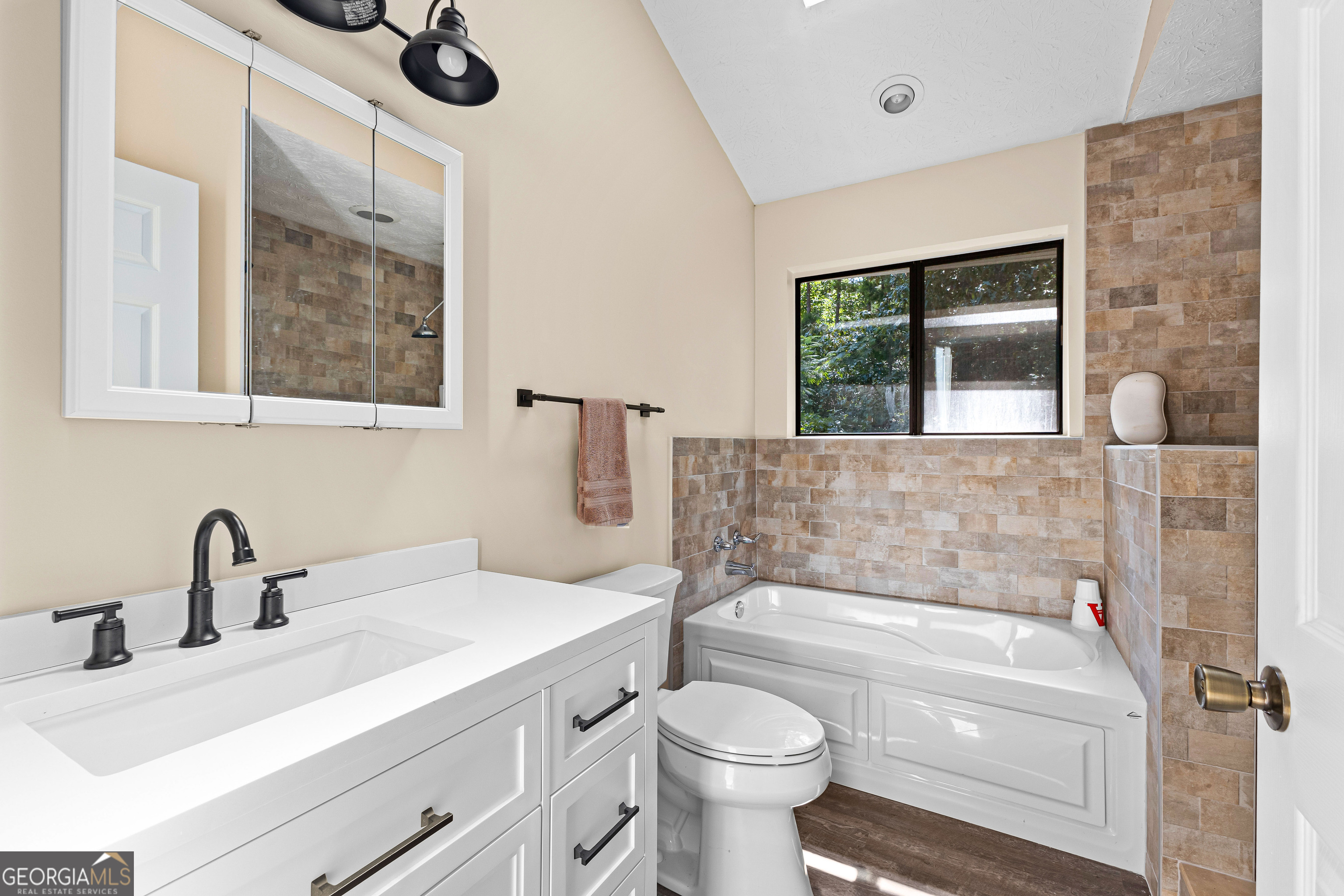 329 Chickadee Court Monticello, GA 31064 - Photo 39 of 59 a bathroom with a sink toilet a mirror and bathtub