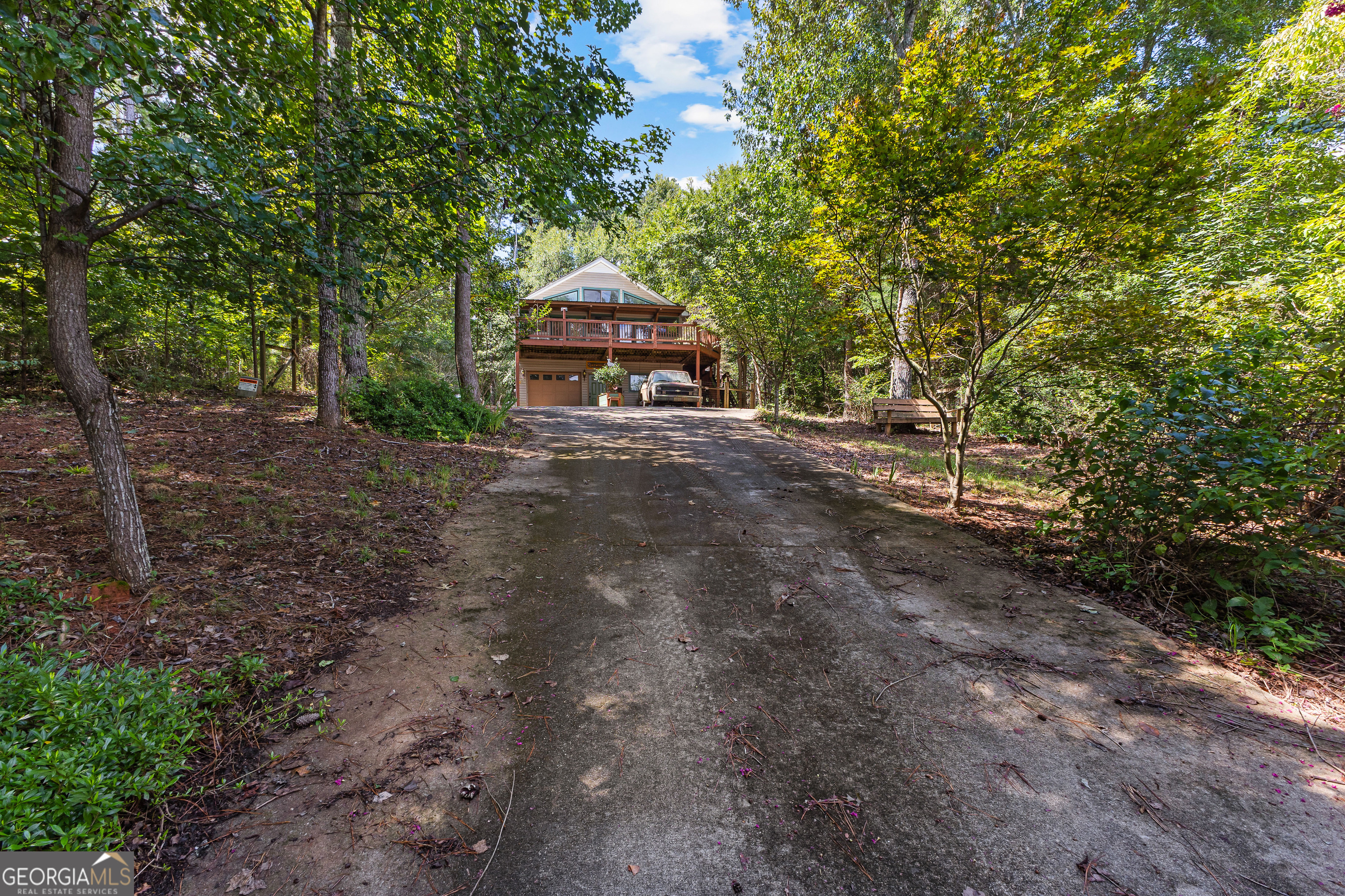 329 Chickadee Court Monticello, GA 31064 - Photo 9 of 59 a dirt road with trees in the background