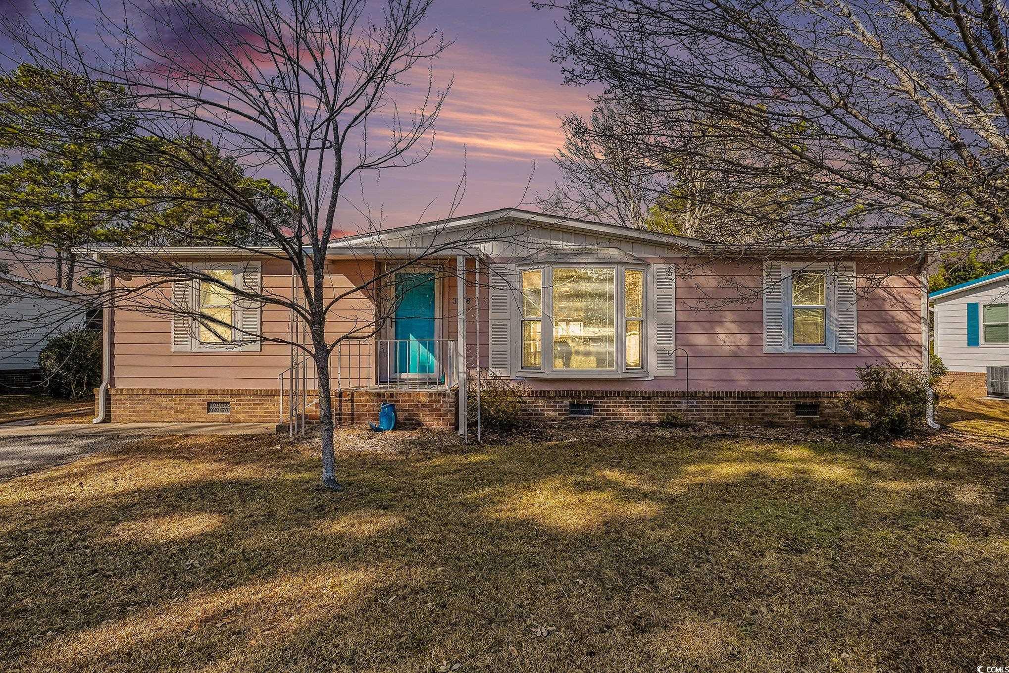 View of front of property featuring crawl space and a yard