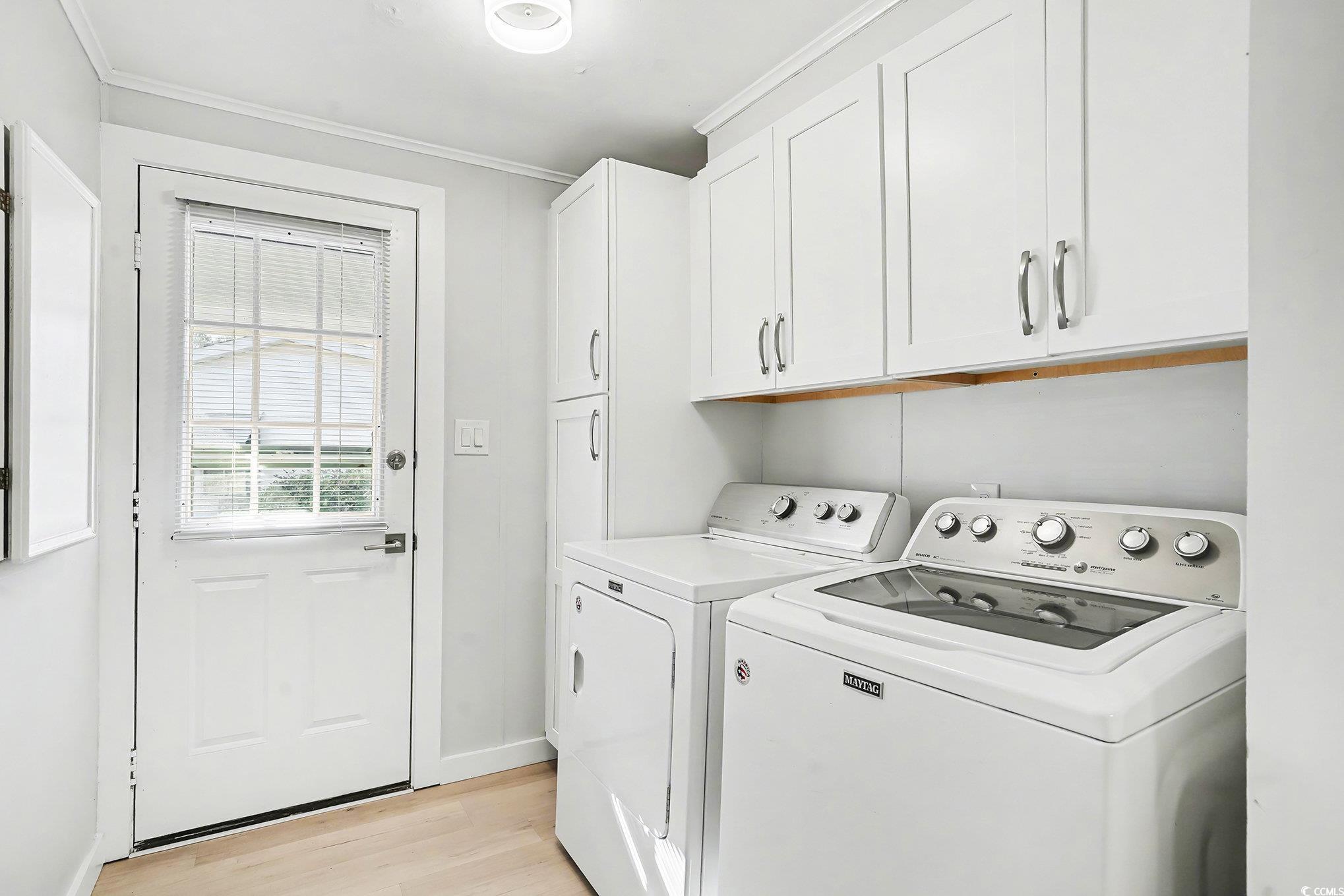 3268 Pecan Trail Murrells Inlet, SC 29576 - Photo 14 of 38 Laundry room featuring light wood-style floors, washing machine and clothes dryer, cabinet space, and ornamental molding
