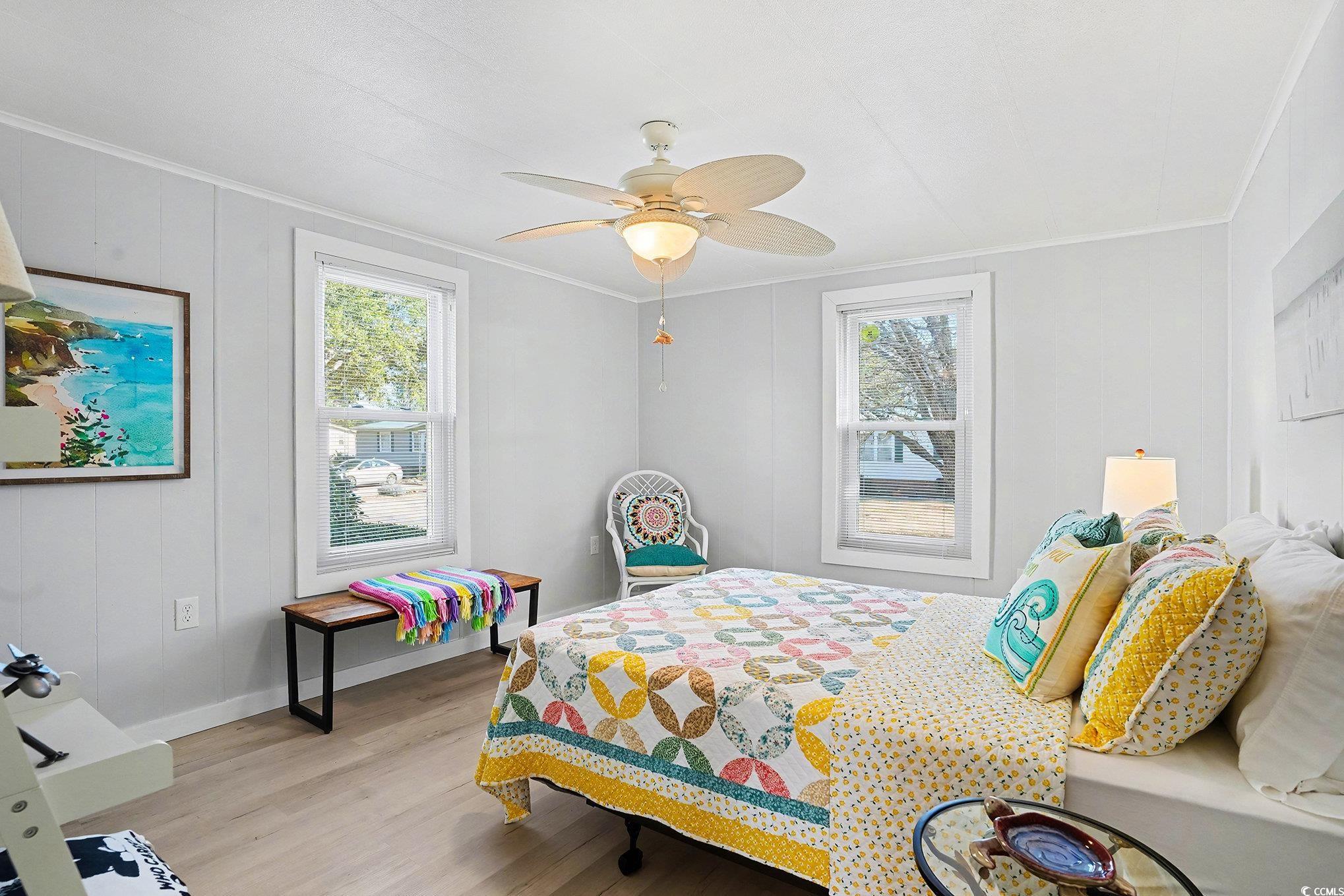 3268 Pecan Trail Murrells Inlet, SC 29576 - Photo 21 of 38 Bedroom with light wood-type flooring, multiple windows, a ceiling fan, and ornamental molding