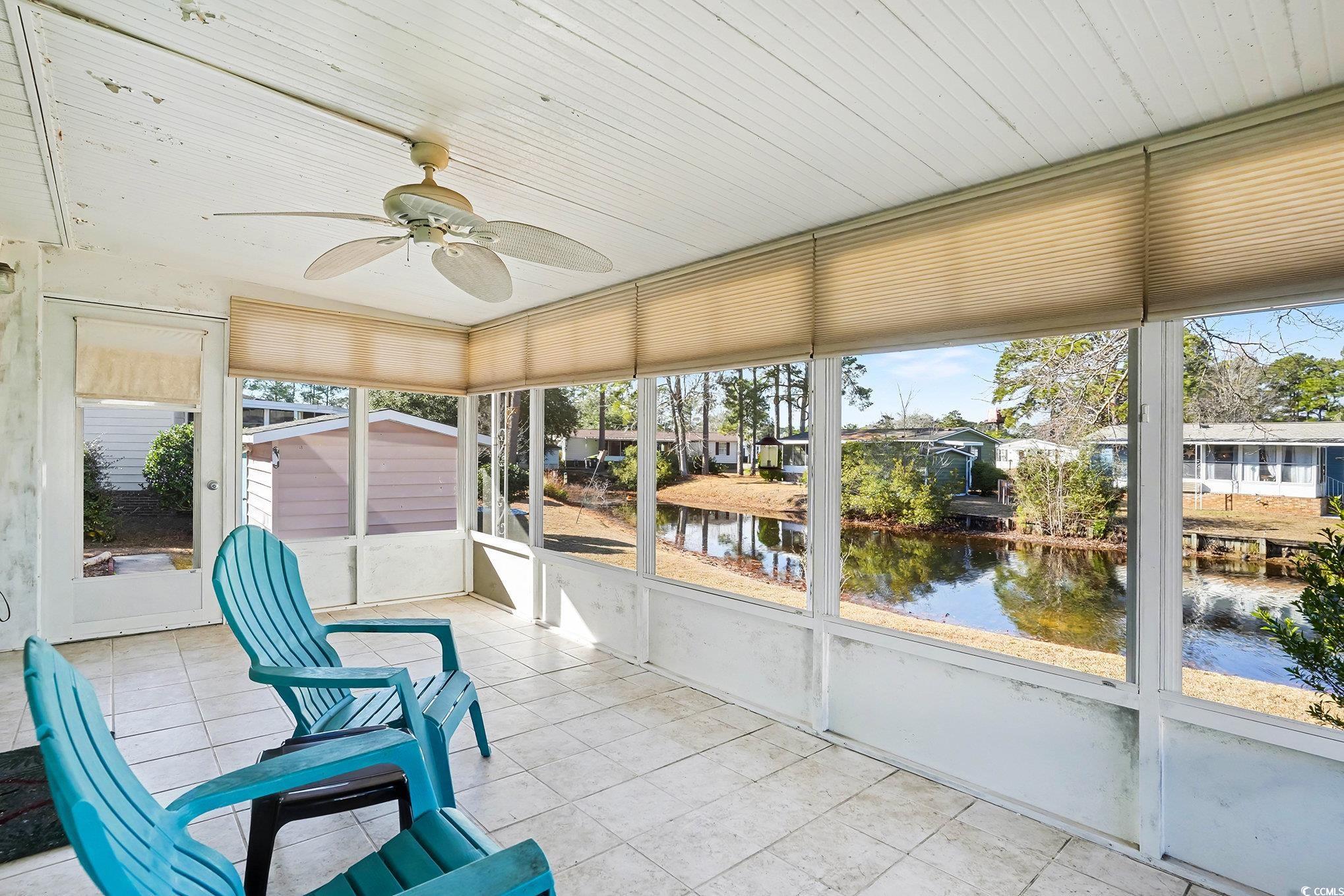 3268 Pecan Trail Murrells Inlet, SC 29576 - Photo 24 of 38 Unfurnished sunroom with a water view and a ceiling fan
