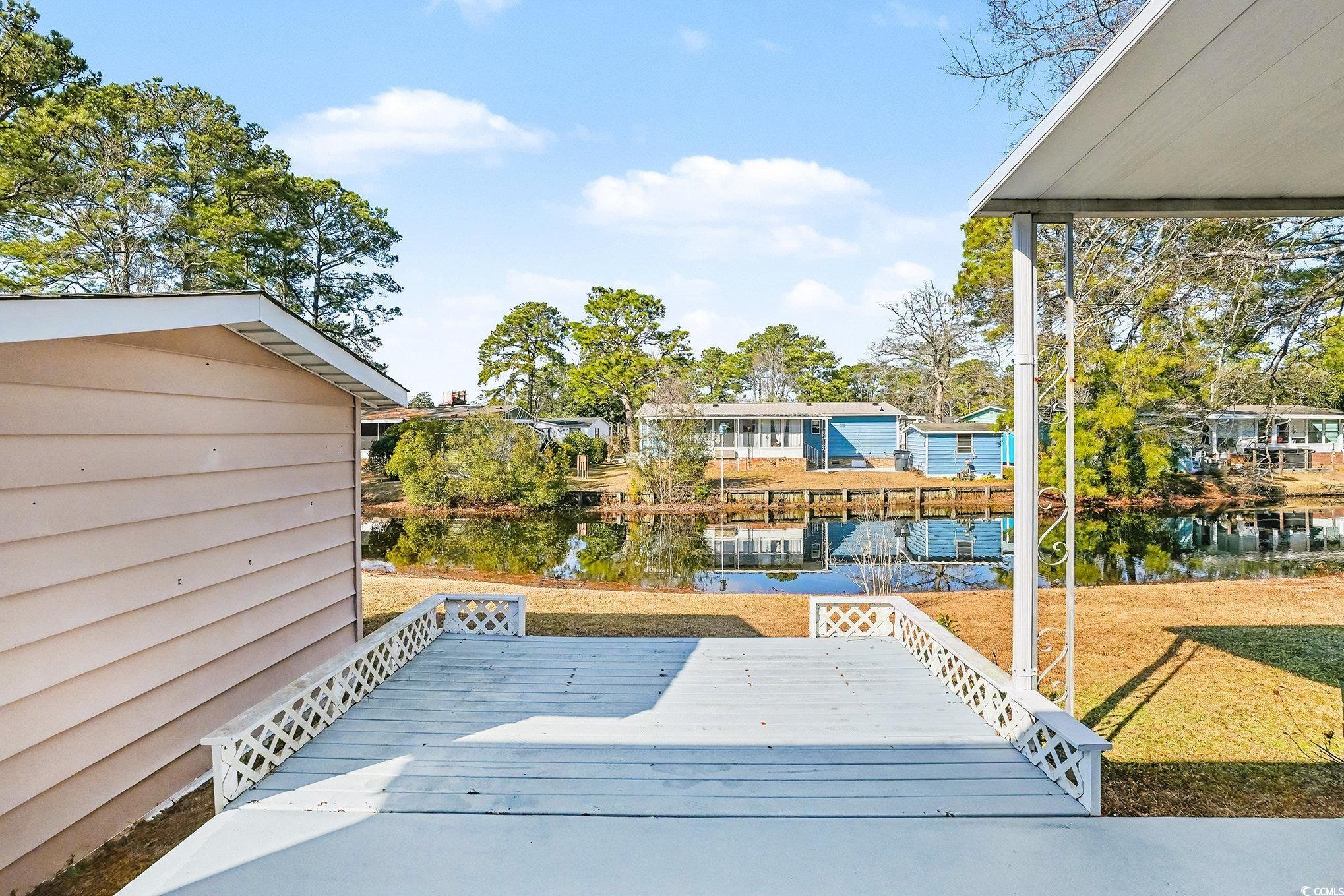3268 Pecan Trail Murrells Inlet, SC 29576 - Photo 27 of 38 Back of property with a sunroom, a deck, and a lawn