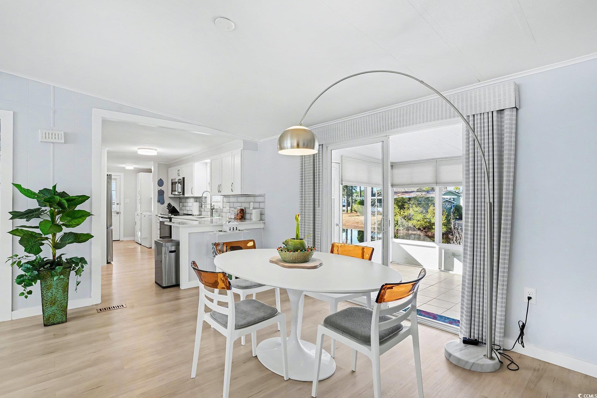 3268 Pecan Trail Murrells Inlet, SC 29576 - Photo 8 of 38 Dining room featuring light wood-style floors and ornamental molding