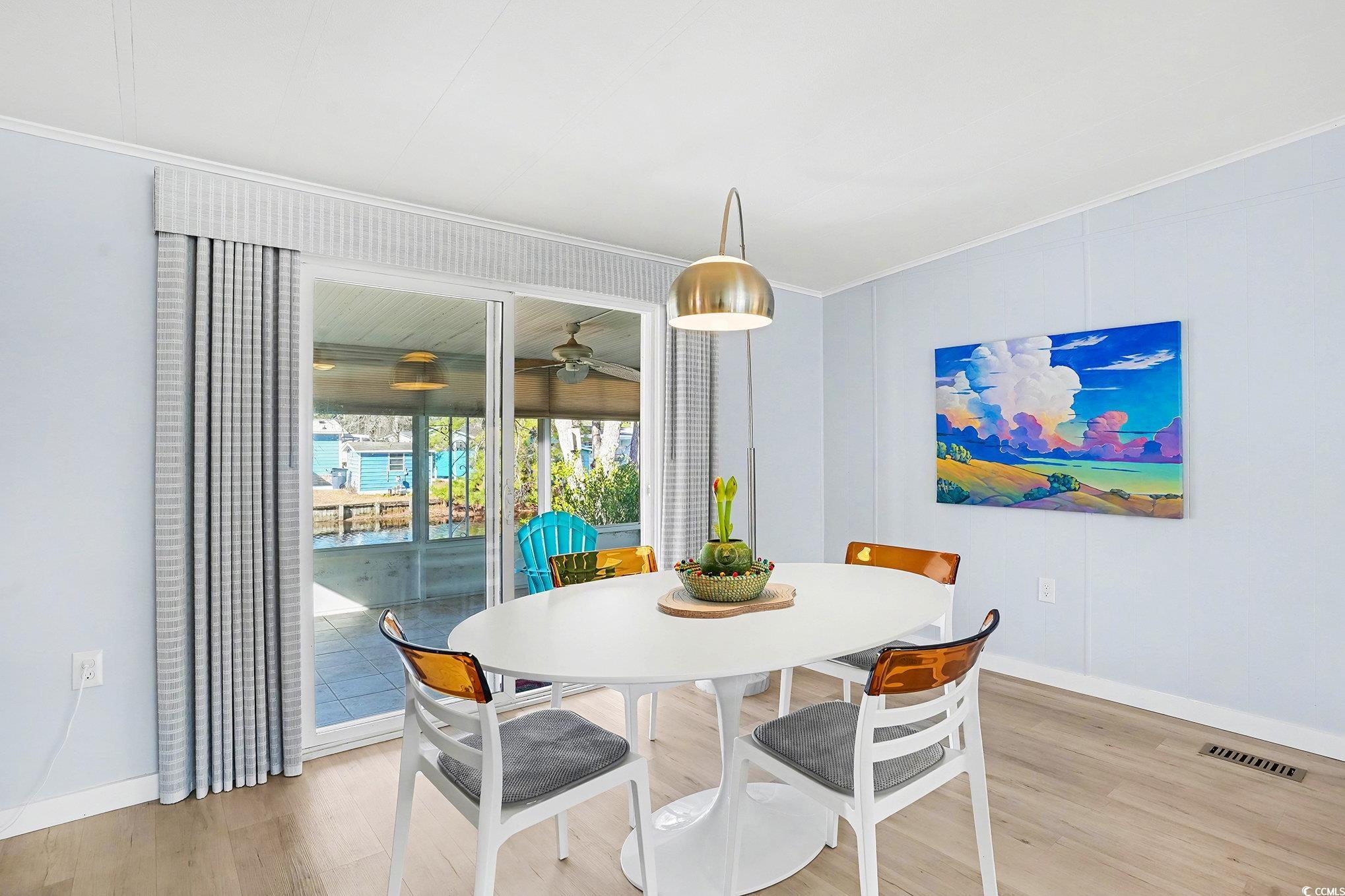 3268 Pecan Trail Murrells Inlet, SC 29576 - Photo 9 of 38 Dining space with wood finished floors, a sunroom, and ornamental molding