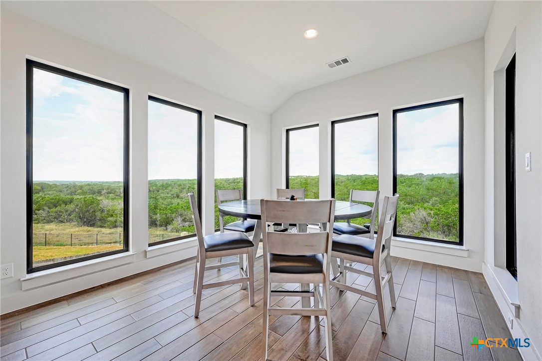 132 Lambs Ear Path San Marcos, TX 78666 - Photo 14 of 43 a dining room with furniture and wooden floor