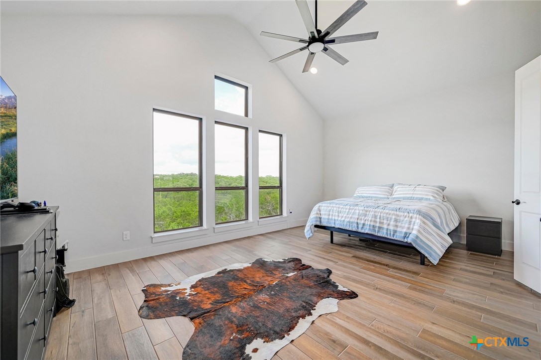 132 Lambs Ear Path San Marcos, TX 78666 - Photo 17 of 43 a bedroom with a bed window and wooden floor