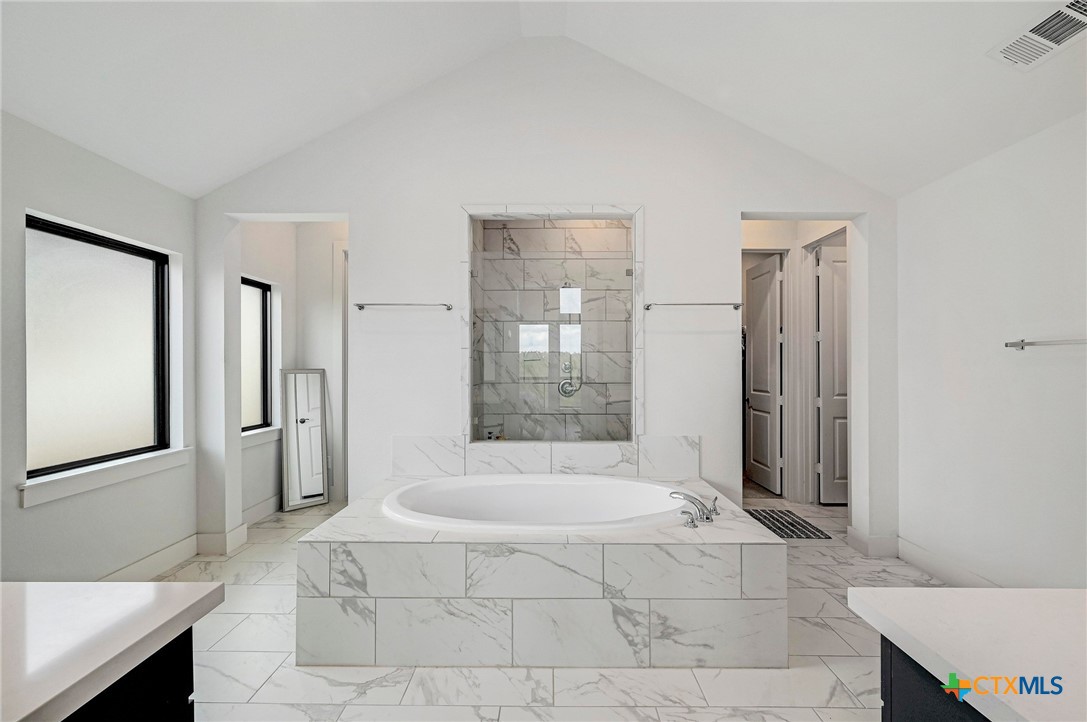 132 Lambs Ear Path San Marcos, TX 78666 - Photo 18 of 43 a spacious bathroom with a glass shower door