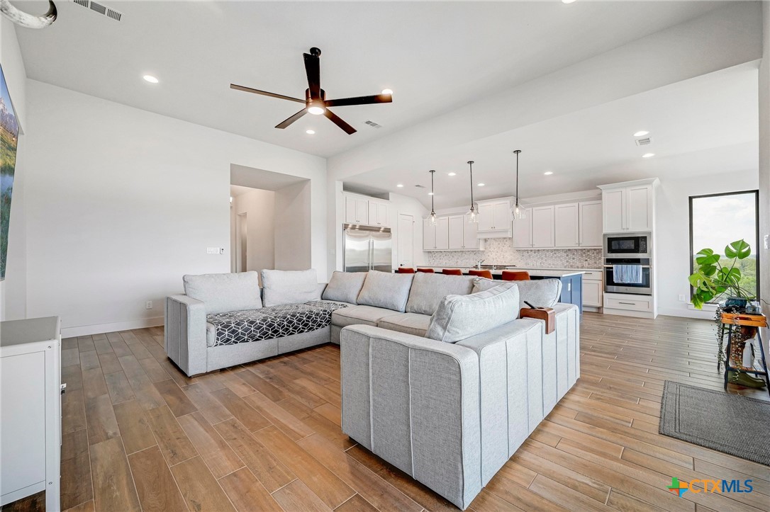 132 Lambs Ear Path San Marcos, TX 78666 - Photo 8 of 43 a living room with furniture and a chandelier