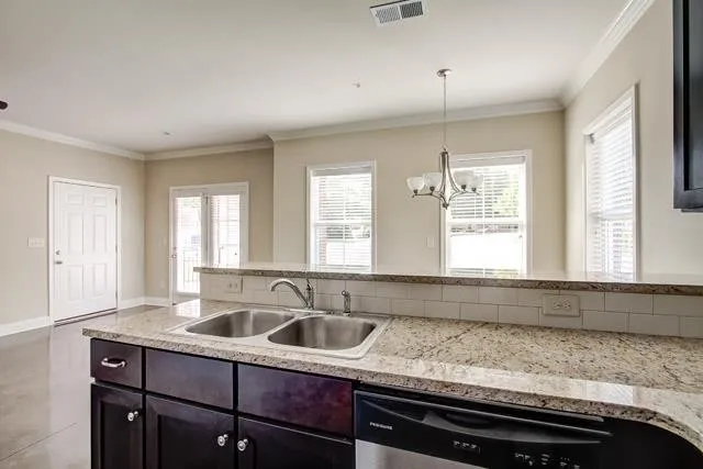 a kitchen with sink window and cabinets