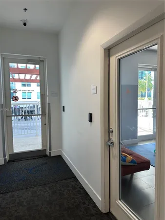 a lobby with furniture and flat screen tv