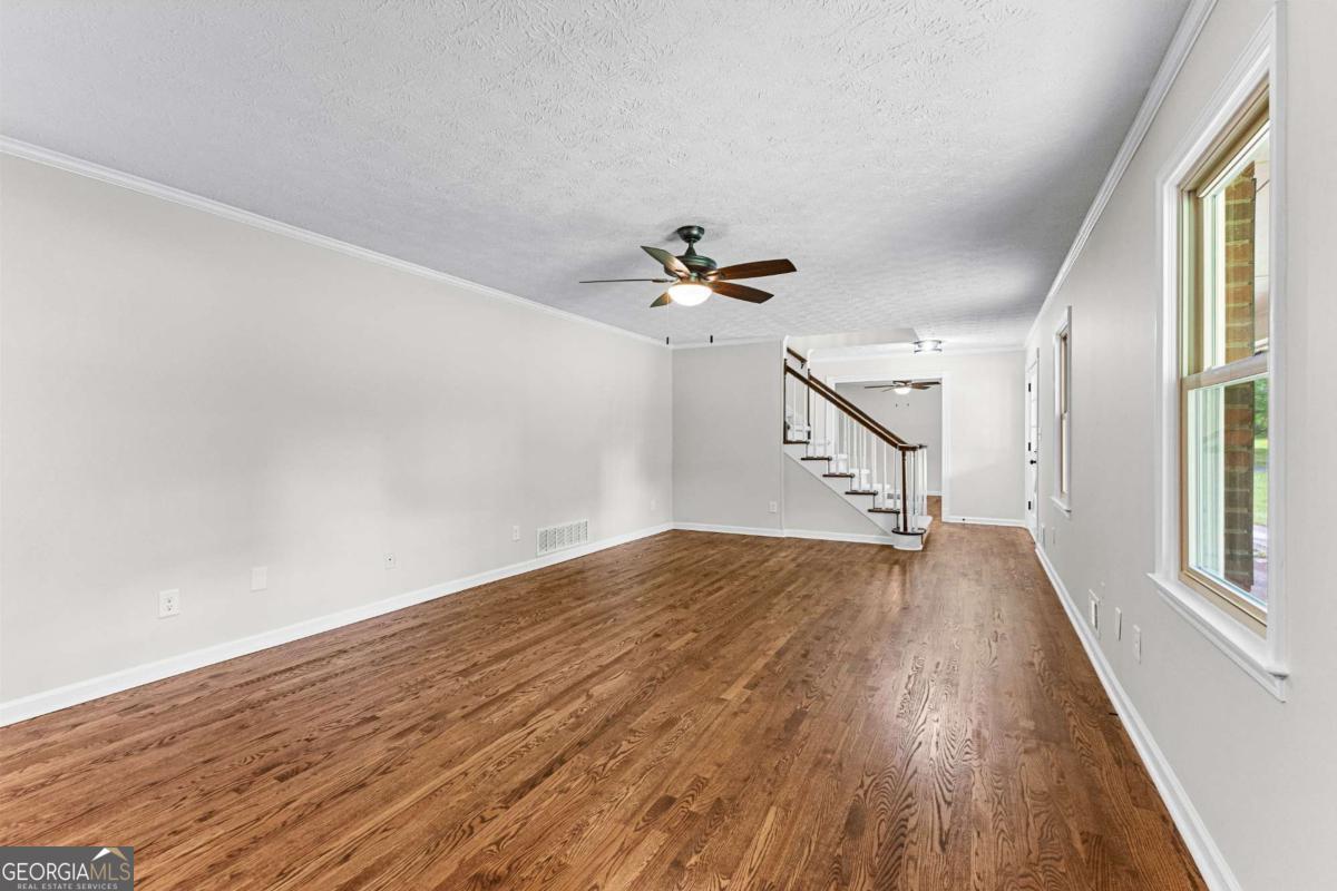 550 Davis Road Fayetteville, GA 30215 - Photo 12 of 75 wooden floor in an empty room with a window
