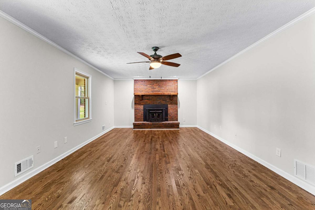 550 Davis Road Fayetteville, GA 30215 - Photo 13 of 75 wooden floor in an empty room with a window