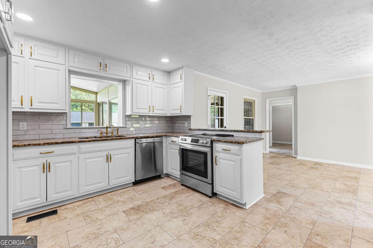 550 Davis Road Fayetteville, GA 30215 - Photo 18 of 75 a kitchen with stainless steel appliances granite countertop a stove a sink and a refrigerator