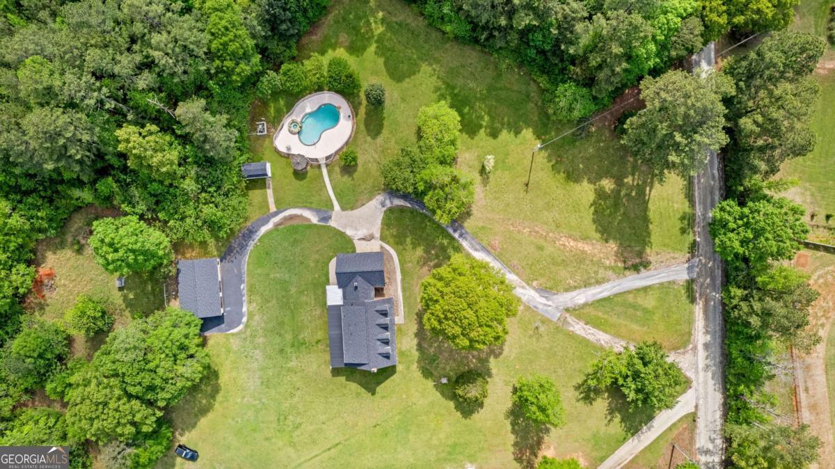550 Davis Road Fayetteville, GA 30215 - Photo 2 of 75 an aerial view of a house with swimming pool and large trees