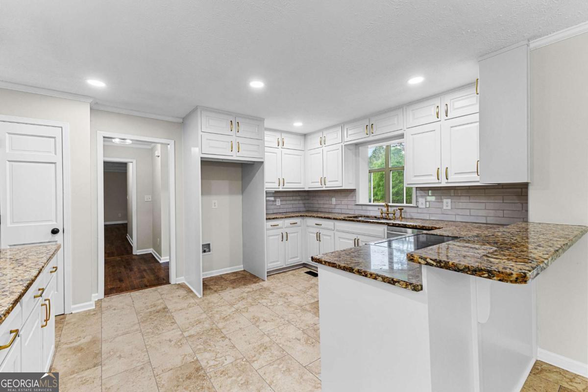 550 Davis Road Fayetteville, GA 30215 - Photo 29 of 75 a kitchen with stainless steel appliances granite countertop a refrigerator sink and cabinets