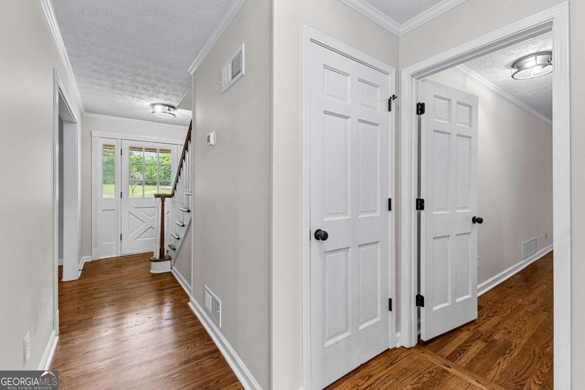 550 Davis Road Fayetteville, GA 30215 - Photo 32 of 75 a view of a hallway with wooden floor and staircase