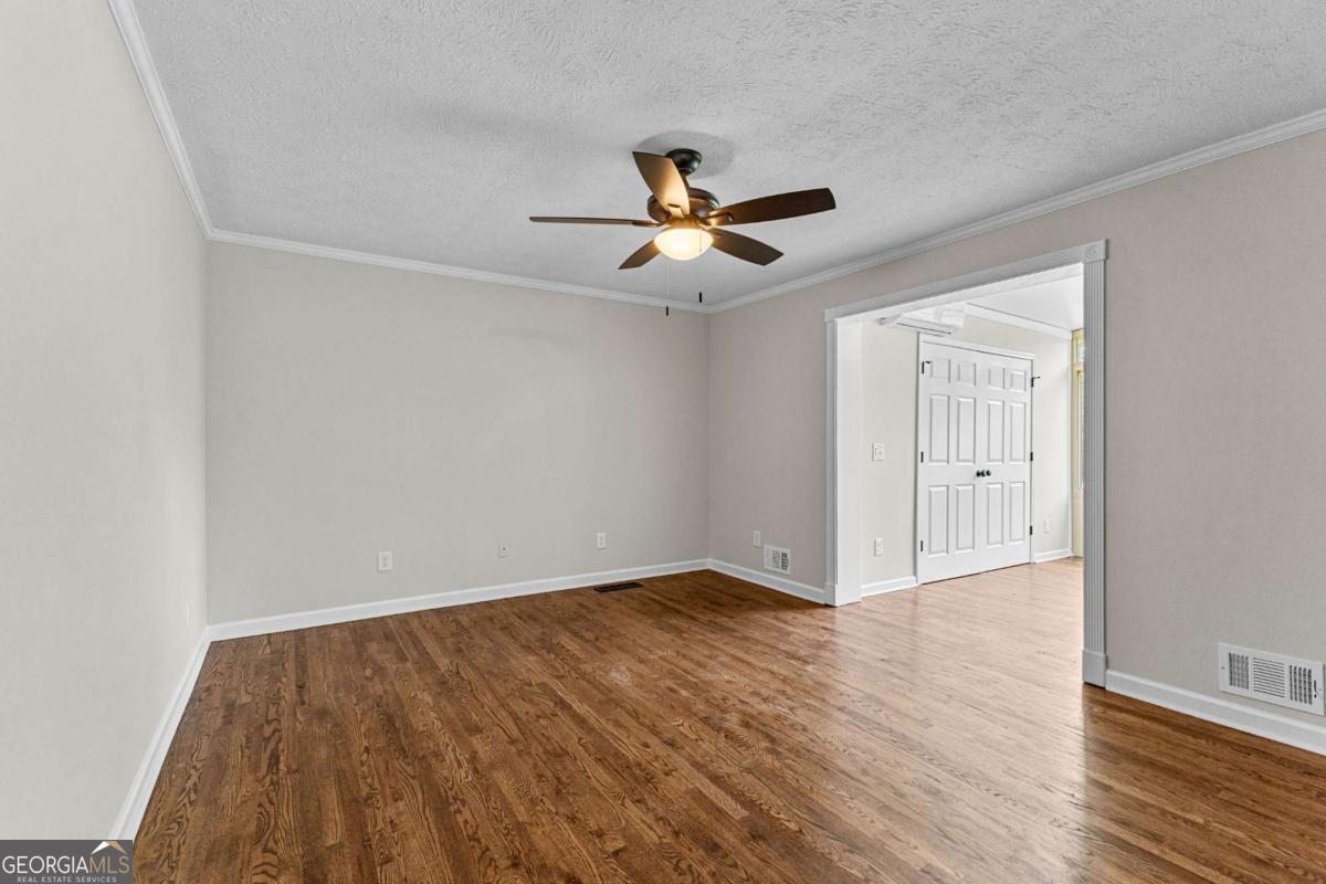 550 Davis Road Fayetteville, GA 30215 - Photo 34 of 75 wooden floor in an empty room with a window