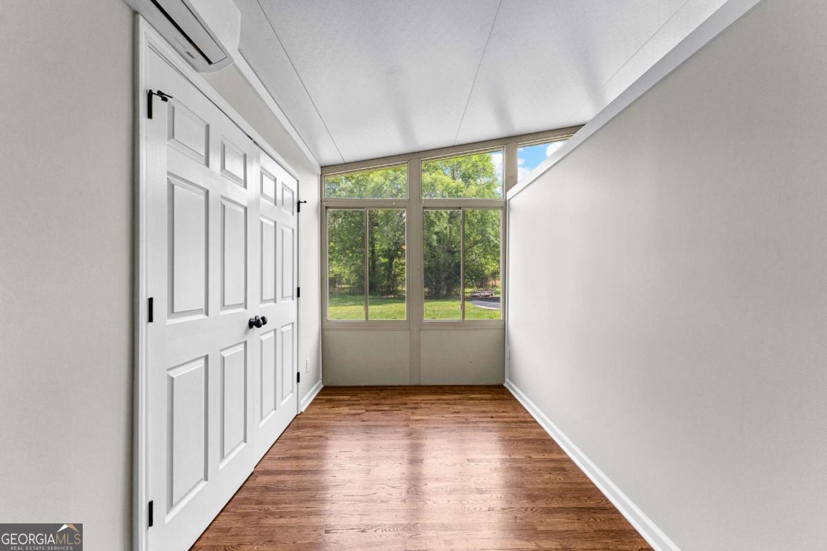 550 Davis Road Fayetteville, GA 30215 - Photo 38 of 75 an empty room with wooden floor and windows