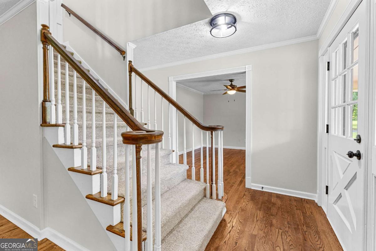 550 Davis Road Fayetteville, GA 30215 - Photo 40 of 75 a view of entryway and hall with wooden floor