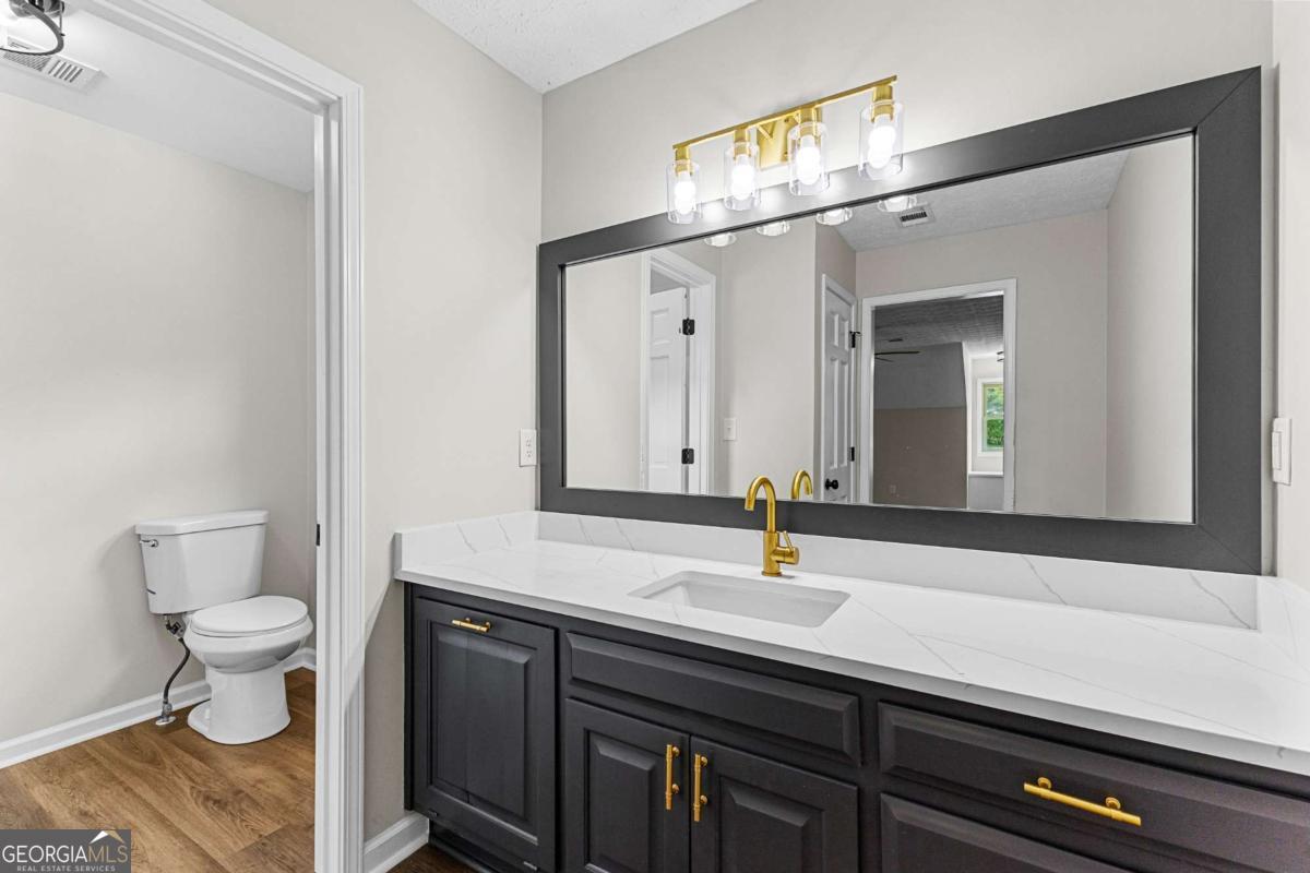 550 Davis Road Fayetteville, GA 30215 - Photo 45 of 75 a bathroom with a sink a toilet and mirror