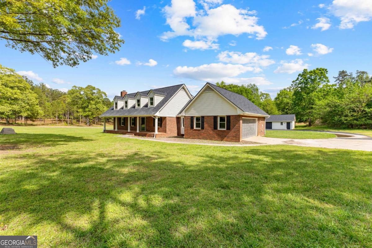 550 Davis Road Fayetteville, GA 30215 - Photo 5 of 75 a front view of a house with a big yard