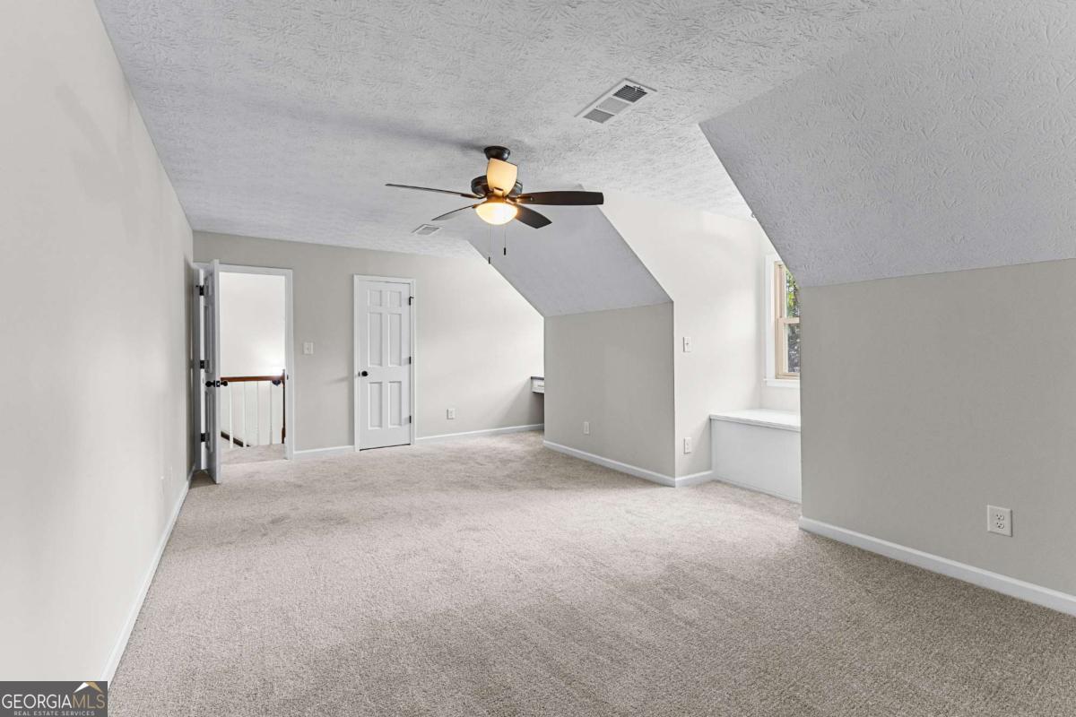 550 Davis Road Fayetteville, GA 30215 - Photo 55 of 75 a view of a big room with a ceiling fan and entryway