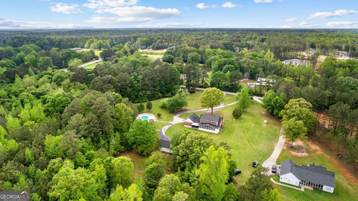550 Davis Road Fayetteville, GA 30215 - Photo 60 of 75 an aerial view of residential houses with outdoor space and trees