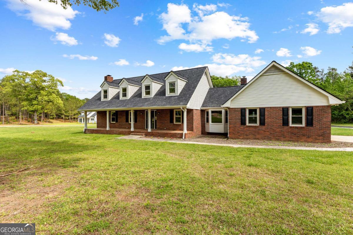 550 Davis Road Fayetteville, GA 30215 - Photo 6 of 75 a front view of a house with a garden