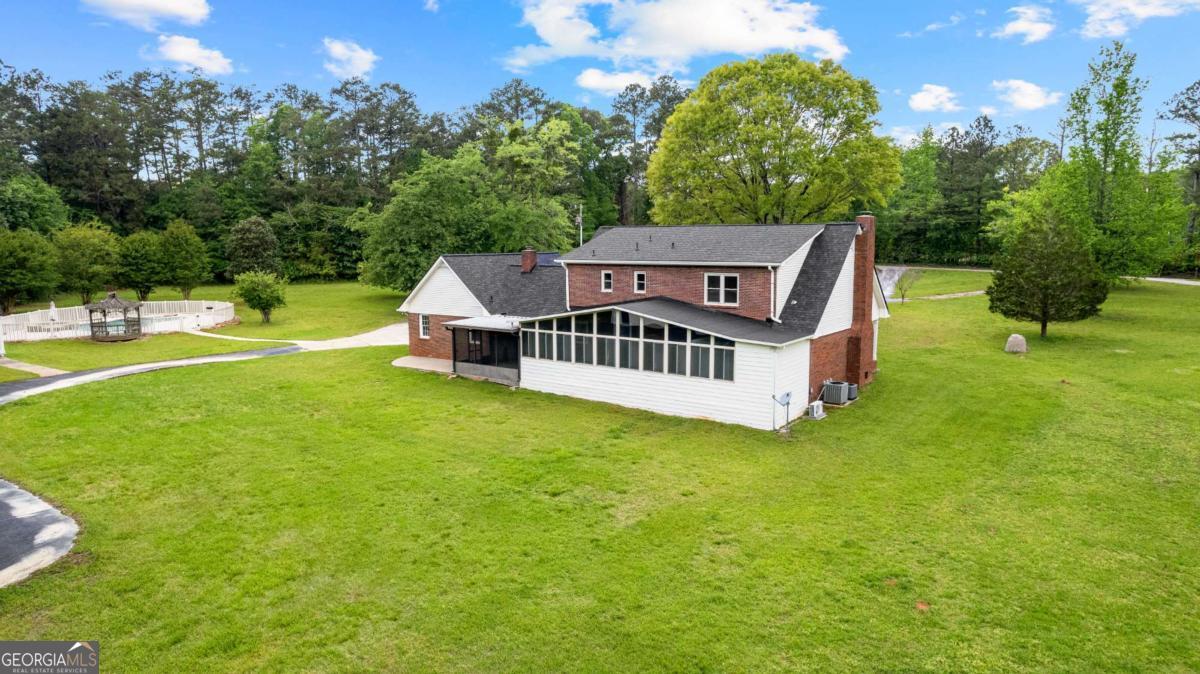 550 Davis Road Fayetteville, GA 30215 - Photo 61 of 75 a view of a house with a big yard potted plants and large tree