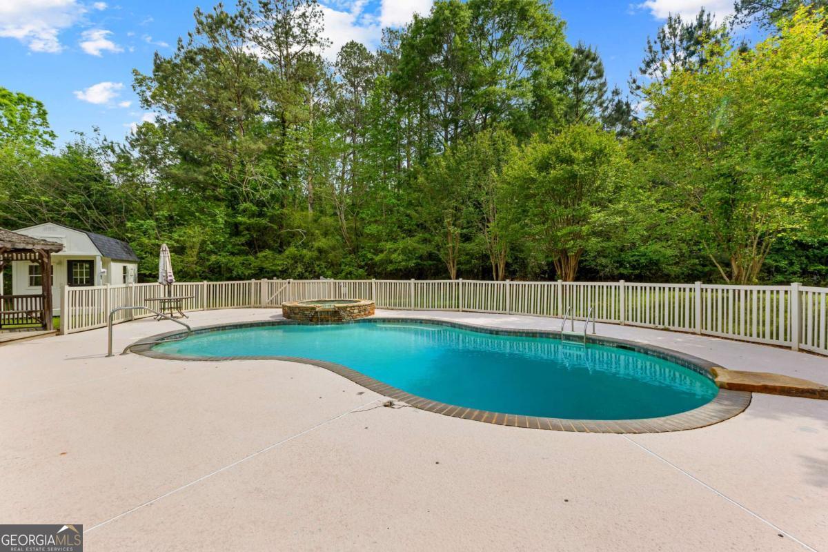 550 Davis Road Fayetteville, GA 30215 - Photo 69 of 75 a view of a swimming pool with a garden