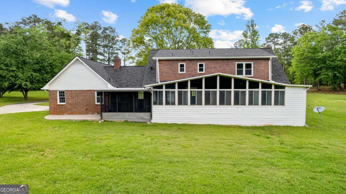 550 Davis Road Fayetteville, GA 30215 - Photo 73 of 75 a view of a house with a yard and a deck