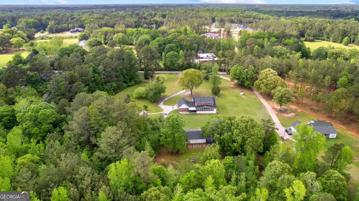 550 Davis Road Fayetteville, GA 30215 - Photo 74 of 75 an aerial view of residential houses with outdoor space and trees