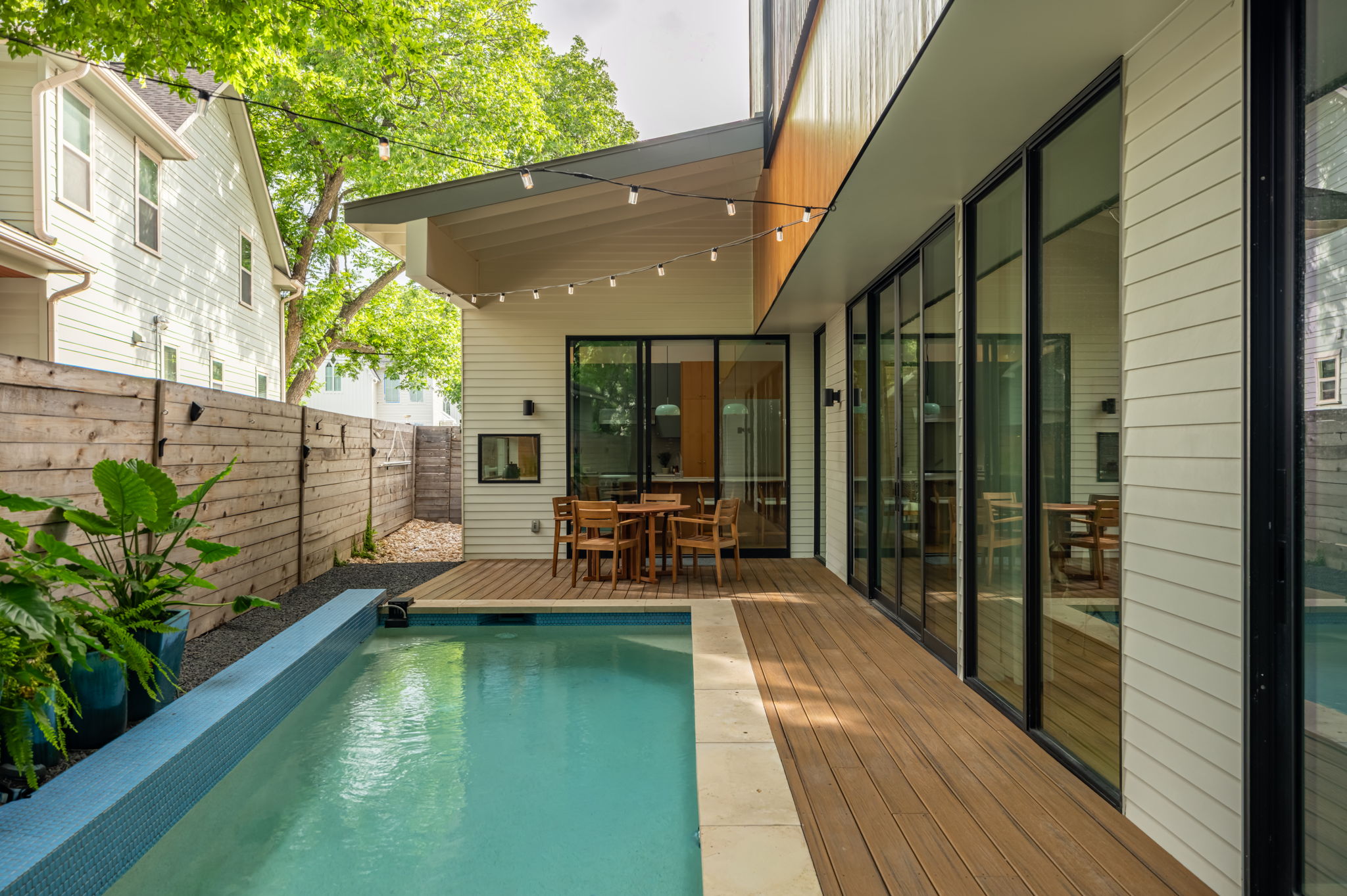 1811 Collier Street Austin, TX 78704 - Photo 33 of 40 Modern exterior with an aqua-tiled swimming pool and composite wood deck