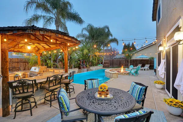 a view of a patio with swimming pool table and chairs