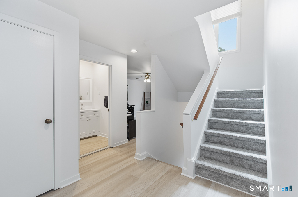 690 Forest Road, Unit 791 West Haven, CT 06516 - Photo 18 of 31 Stairs to upper level and guest half bath in hallway