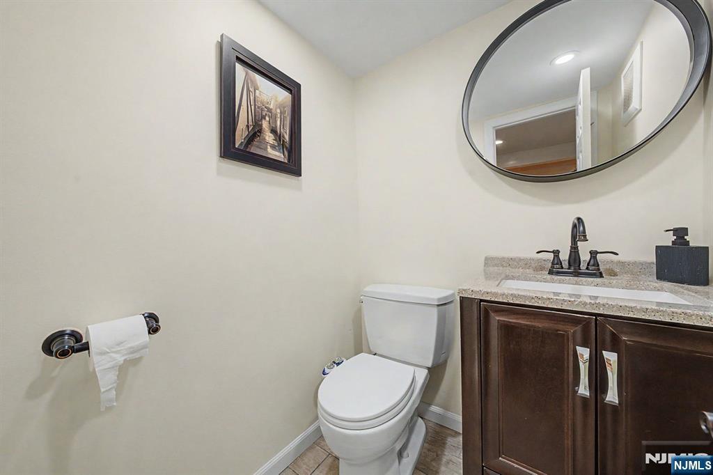 45 Highfield Road Bloomfield, NJ 07003 - Photo 41 of 50 a bathroom with a toilet a sink and mirror